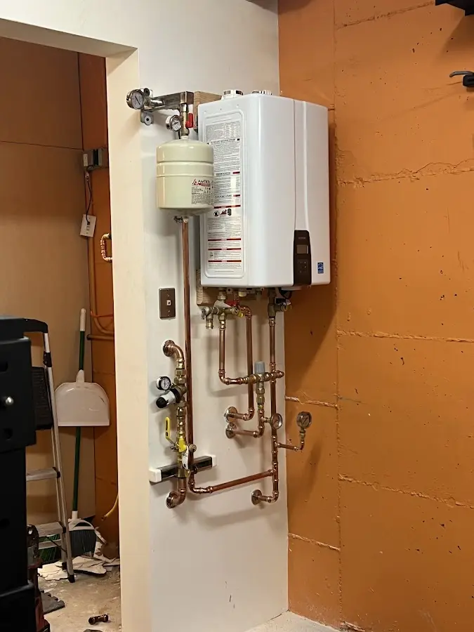 Plumbing technician inspecting water heater connections in Carlyss